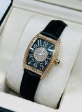This is a GUOU quartz watch with a black dial, diamond accents, and a black strap.