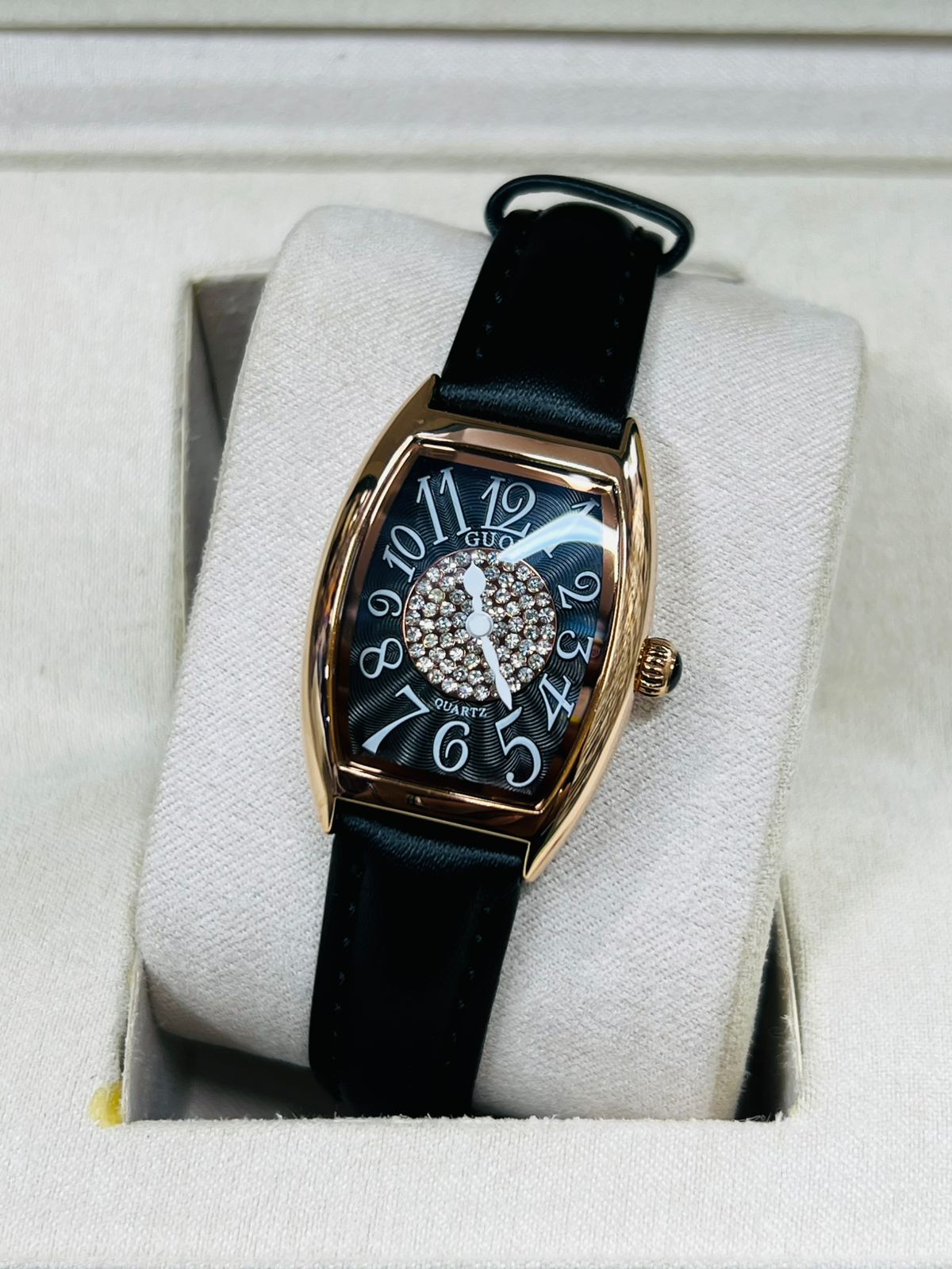 This is a GUOU quartz watch with a black dial, diamond accents, and a black strap.